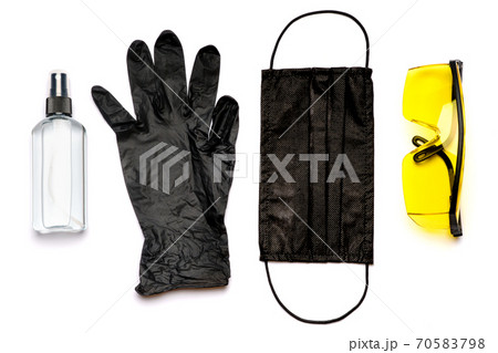 Safety equipment to fight to Coronavirus COVID-19 virus outbreak - Safety mask, hand sanitizer, latex gloves and protective glasses or goggles 70583798