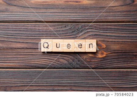 queen word written on wood block. queen text on cement table for your desing, concept queen word written on wood block. queen text on cement table for your desing, concept 70584023