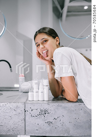 painting of a woman with cosmetic bottles in the bathroom 70585684