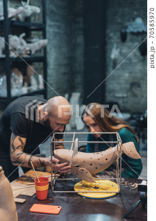 People carefully work on clay whale in workshop People carefully work on clay whale in workshop 70585970