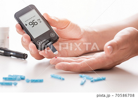 Diabetes checking blood sugar level 70586708