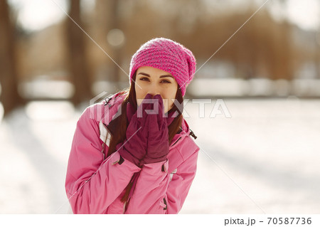 Woman in winter sports clothes looking at camera Woman in winter sports clothes looking at camera 70587736