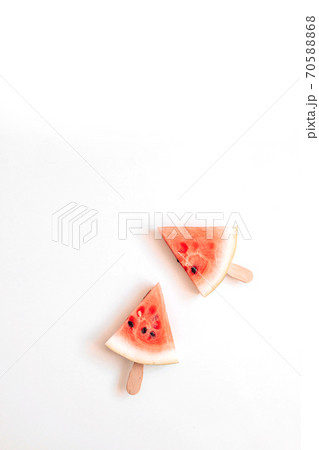 Ripe slice of watermelon in the form of a lelen on a stick on a white background. Healthy food. Ripe slice of watermelon in the form of a lelen on a stick on a white background. Healthy food. 70588868