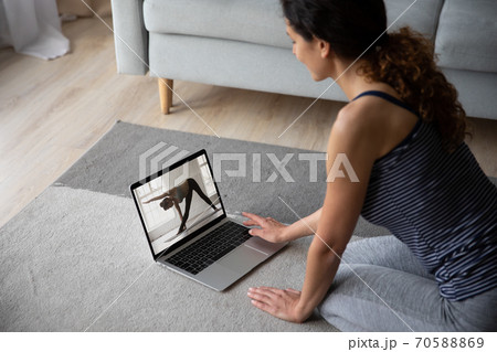 Young woman wearing sportswear watching webinar, training at home 70588869