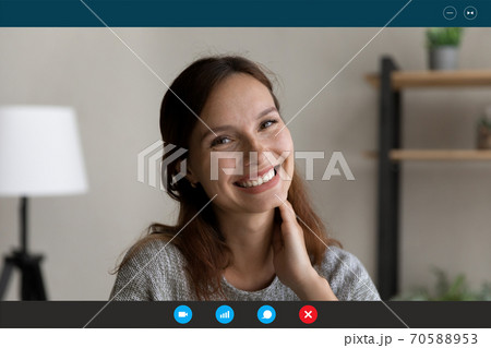 Head shot portrait screen view smiling young woman chatting online Head shot portrait screen view smiling young woman chatting online 70588953