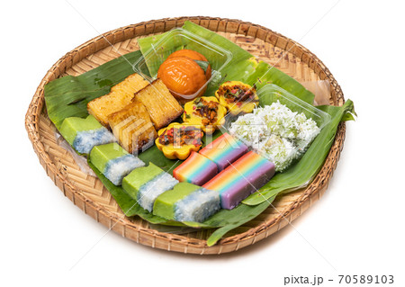 Assorted nyonya kueh on banana leaf rattan tray Assorted nyonya kueh on banana leaf rattan tray 70589103