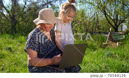 Granddaughter teaches grandma to work on computer 70589126
