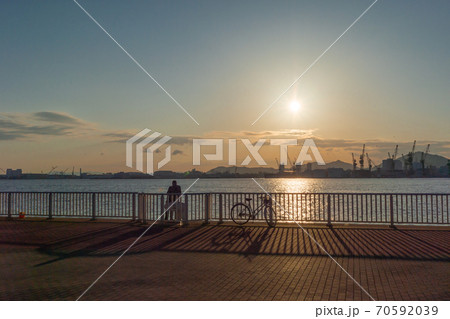 夕日の沈む風景 神戸のポートアイランド しおさい公園 10月初旬 魚を釣る人の写真素材