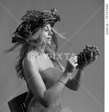 Portrait of  beautiful caucasian blonde woman with grapes. 70593480