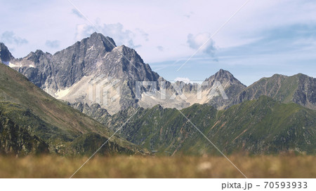 The high mountains of the Austrian Alps in Kuhtai during summer season. The sunshine illuminates the beautiful landscape. 70593933