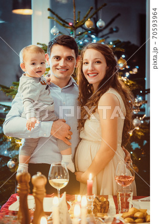 Family with toddler and pregnant wife celebrating Christmas Family with toddler and pregnant wife celebrating Christmas 70593964