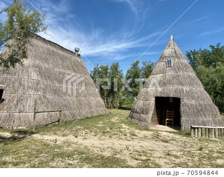 Typical old fisher houses made of reed in the beautiful lagoon of Caorle near Venice in Italy Typical old fisher houses made of reed in the beautiful lagoon of Caorle near Venice in Italy 70594844