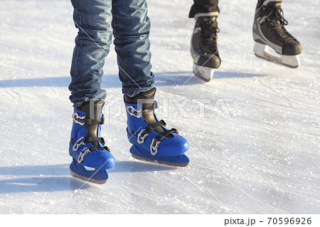 different people are actively skating on an ice rink. hobbies and leisure. winter sports 70596926