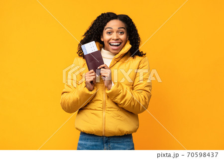 Joyful African American Traveler Woman Holding Tickets Over Yellow Background Joyful African American Traveler Woman Holding Tickets Over Yellow Background 70598437