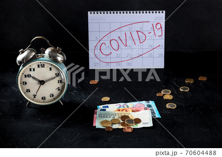 Covid 19 economical crisis in Europe, economical consequences of lockdowns. A clock, monthly calendar and money Covid 19 economical crisis in Europe, economical consequences of lockdowns. A clock, monthly calendar and money 70604488