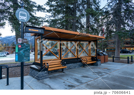 Street view of Town of Banff. Bus stop in Banff Avenue in autumn and winter snowy season. Banff, Alberta, Canada. Street view of Town of Banff. Bus stop in Banff Avenue in autumn and winter snowy season. Banff, Alberta, Canada. 70606641