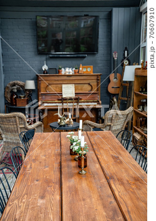 table with candles and flowers in room with piano. table with candles and flowers in room with piano. 70607910