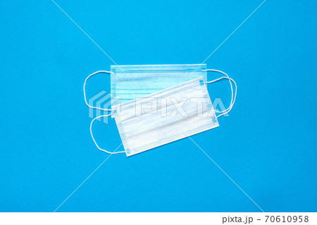 Disposable blue medical face masks on blue background Disposable blue medical face masks on blue background 70610958