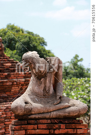 Old Buddha statue damaged without head in the midst of ruins of the Chaiwatthanaram Temple Old Buddha statue damaged without head in the midst of ruins of the Chaiwatthanaram Temple 70615556