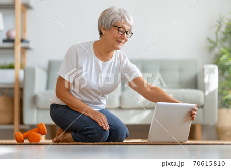 Senior woman exercising at home. 70615810