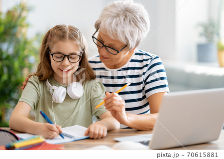 Girl doing homework or online education. Girl doing homework or online education. 70615881