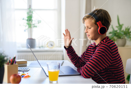 Schoolboy having online lesoon indoors at home, coronavirus concept. 70620151