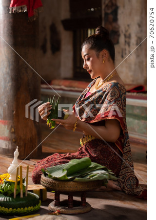 Thai girl in traditional dress costume making and decorating Krathong. Loy Krathong Festival. 70620754