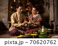 Thai couple in traditional dress costume making and decorating Krathong. Loy Krathong Festival. 70620762