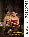 Thai couple in traditional dress costume making and decorating Krathong. Loy Krathong Festival. 70620765