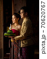 Thai couple in traditional dress costume making and decorating Krathong. Loy Krathong Festival. 70620767