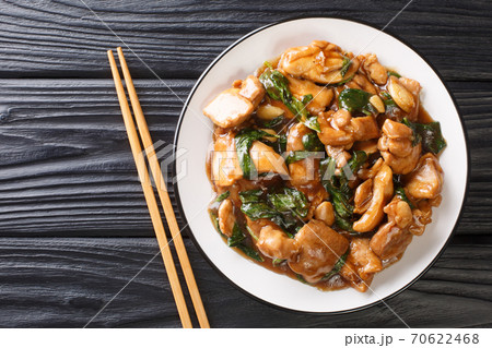 Three Cup Chicken, is a classic Taiwanese dish made by cooking chicken with sesame oil, soy sauce and rice wine close-up in a plate. horizontal top view Three Cup Chicken, is a classic Taiwanese dish made by cooking chicken with sesame oil, soy sauce and rice wine close-up in a plate. horizontal top view 70622468