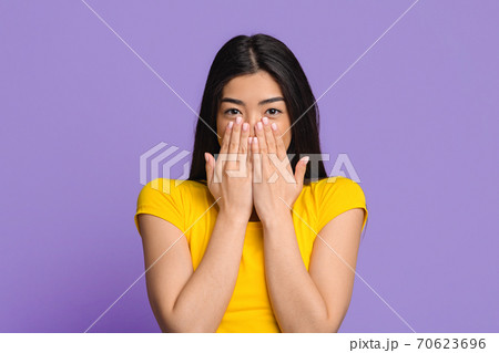 Happy Excitement. Cheerful Brunette Woman Sincerely Smiling And Covering Mouth With Hands, Received Pleasant Surprize, Having Positive Emotions, Standing Over Purple Studio Background, Copy Space Happy Excitement. Cheerful Brunette Woman Sincerely Smiling And Covering Mouth With Hands, Received Pleasant Surprize, Having Positive Emotions, Standing Over Purple Studio Background, Copy Space 70623696