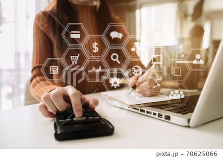 businessman hand using calculator and writing make note with calculate about cost at home office. businessman hand using calculator and writing make note with calculate about cost at home office. 70625066