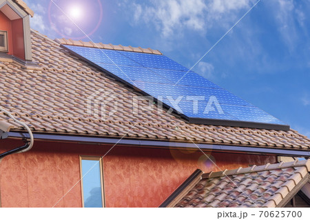 エコ住宅　洋風屋根と太陽光パネルと青空 70625700