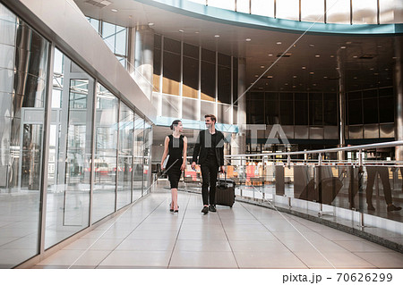 Man and woman going for the business trip together Man and woman going for the business trip together 70626299