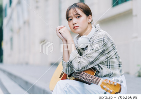 woman playing guitar on the street woman playing guitar on the street 70626698
