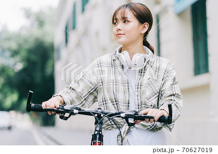 woman cycling on the street 70627019