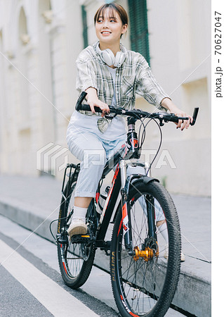 woman cycling on the street 70627047