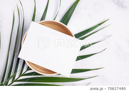 Paper on bamboo a bowl with palm leaf, top view 70627480