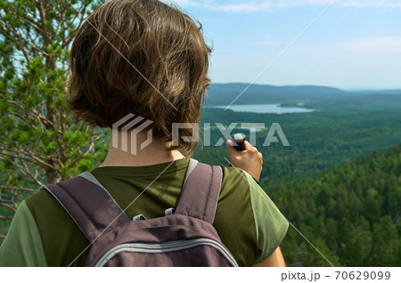Travel woman with backpack looking at lake valley among forest Travel woman with backpack looking at lake valley among forest 70629099