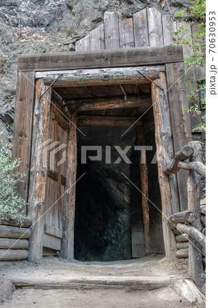 Historical door to bombshelter (anti-aircraft cover) in rock. Abandoned Mine entrance in rock. 70630953