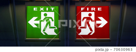 The signpost shows two path directions. Choice of way, Exit and Fire.  70630963