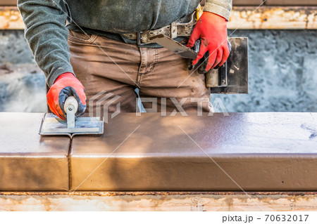 Construction Worker Using Hand Groover On Wet Cement Forming Coping Around New Pool Construction Worker Using Hand Groover On Wet Cement Forming Coping Around New Pool 70632017