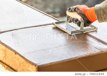 Construction Worker Using Hand Groover On Wet Cement Forming Coping Around New Pool 70632044