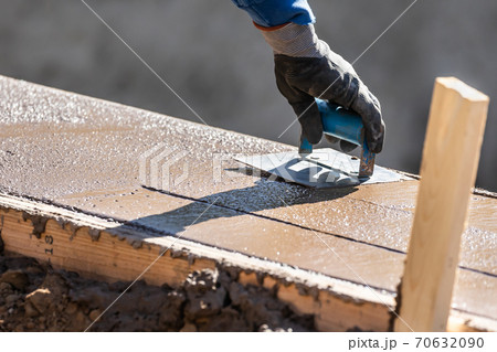 Construction Worker Using Hand Groover On Wet Cement Forming Coping Around New Pool 70632090
