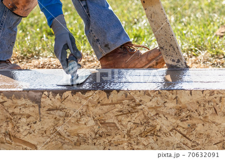 Construction Worker Using Trowel On Wet Cement Forming Coping Around New Pool Construction Worker Using Trowel On Wet Cement Forming Coping Around New Pool 70632091