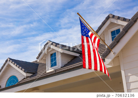 American Flag Hanging From House Facade 70632136