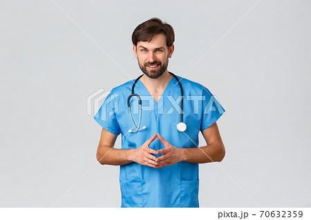 Healthcare workers, coronavirus quarantine campaign and pandemic concept. Thoughtful, genius doctor or nurse in blue scrubs and stethoscope, look sly or scheming, having excellent plan fight disease 70632359
