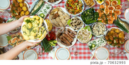 A lot of different food on the Banquet table and served boiled potatoes with dill.A large number of ready-made dishes on the table.Holiday at the table A lot of different food on the Banquet table and served boiled potatoes with dill.A large number of ready-made dishes on the table.Holiday at the table 70632993