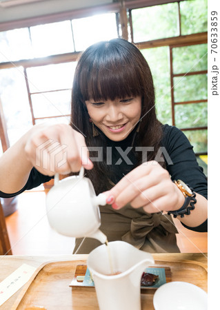 A long-haired Japanese woman drinks traditional tea in Taiwan. A long-haired Japanese woman drinks traditional tea in Taiwan. 70633859
